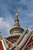 Bangkok Wat Arun - Detail of the entrance of the ubosot. The spire is decorated with polychromatic mosaic flowers made from ceramic chips. 